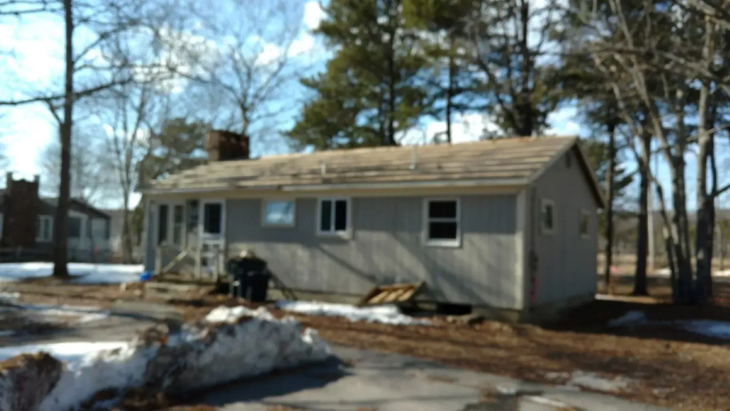 A small house in the middle of a snowy field
