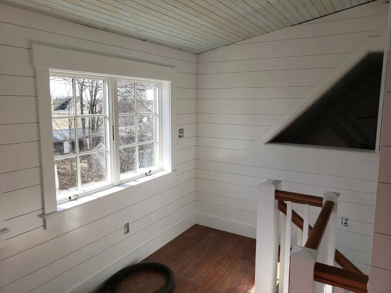 A room with white walls and a large window