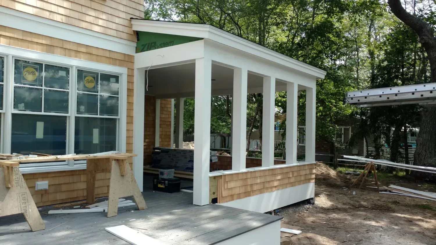 A porch is being built on the side of a house.