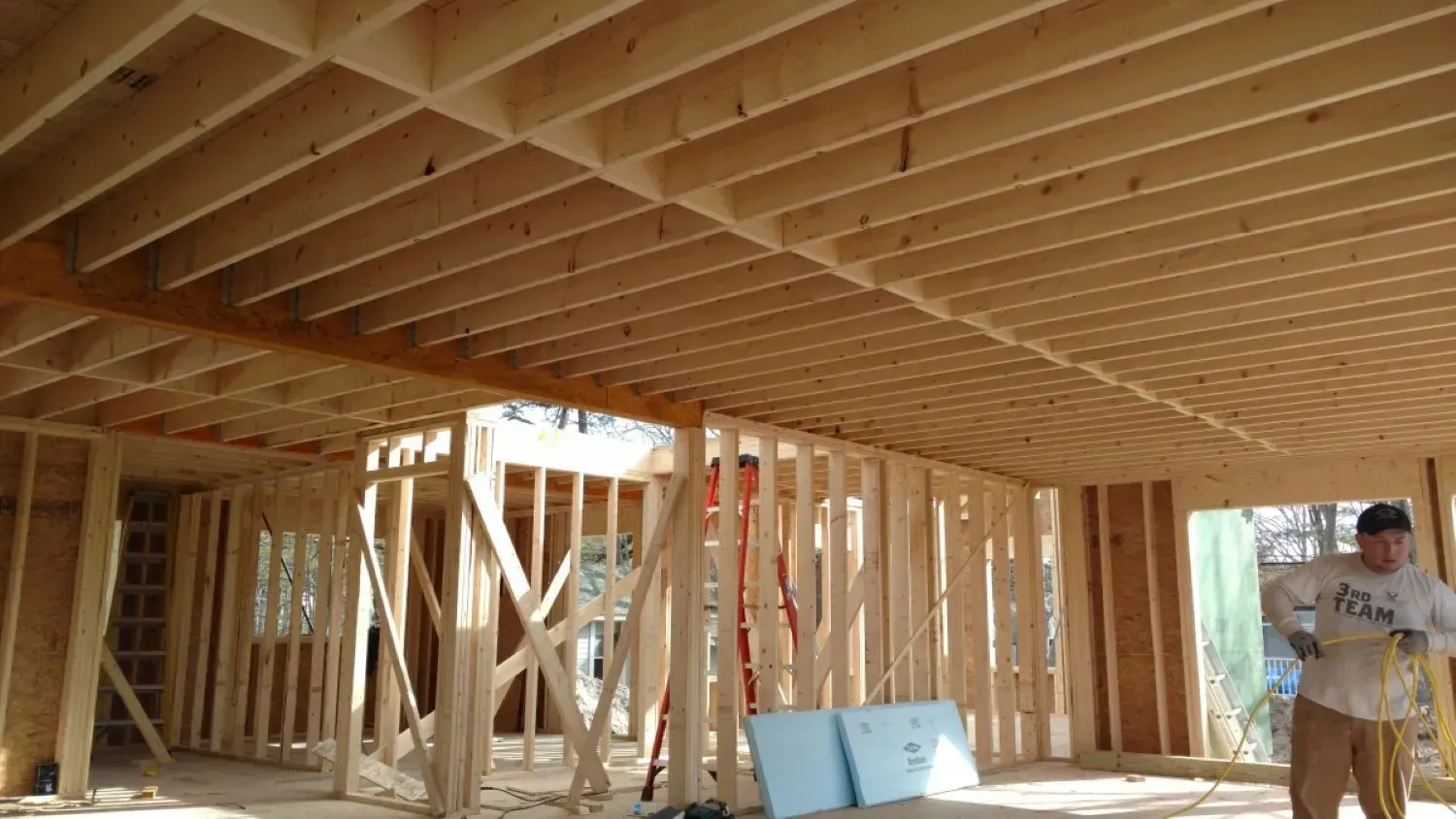 A man is standing in the middle of a building under construction.
