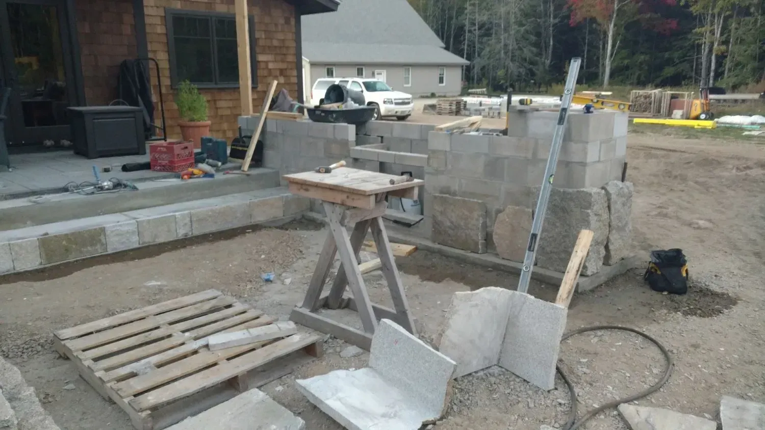 A brick wall is being built on a construction site.