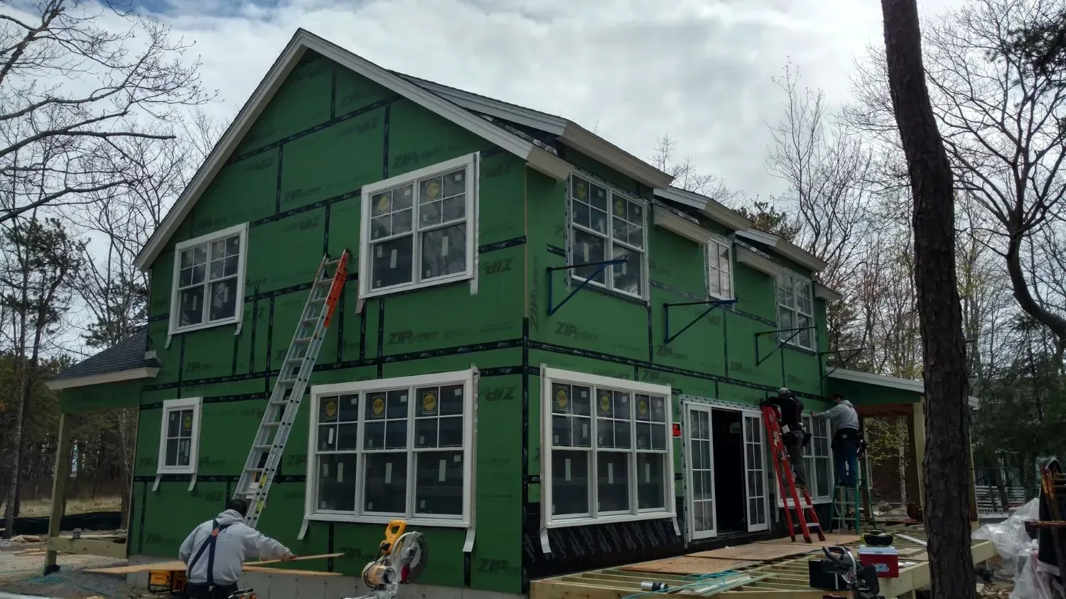 A green house is being built with a lot of windows.
