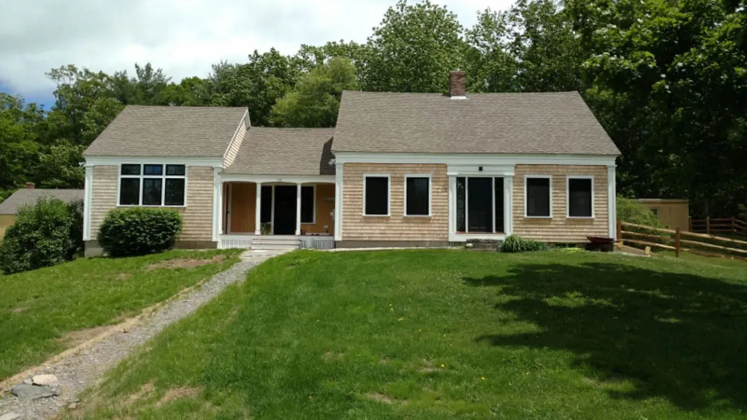 A house with a large lawn in front of it