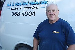 A man in a blue shirt is standing in front of a white van.