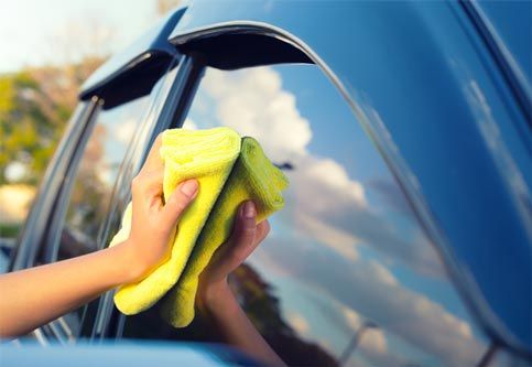 Cleaning car window - Auto glass repair in Kankakee, IL