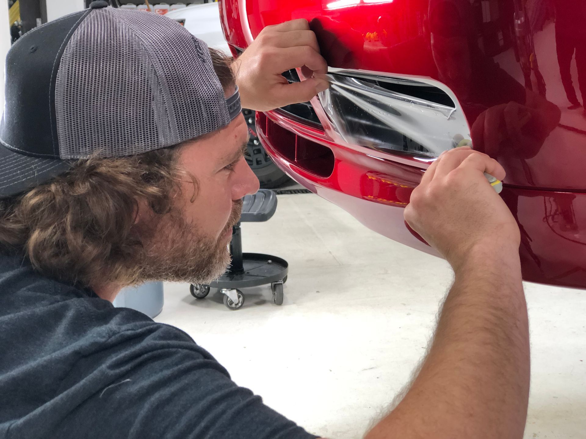 Two tesla cars are parked next to each other in a parking lot.