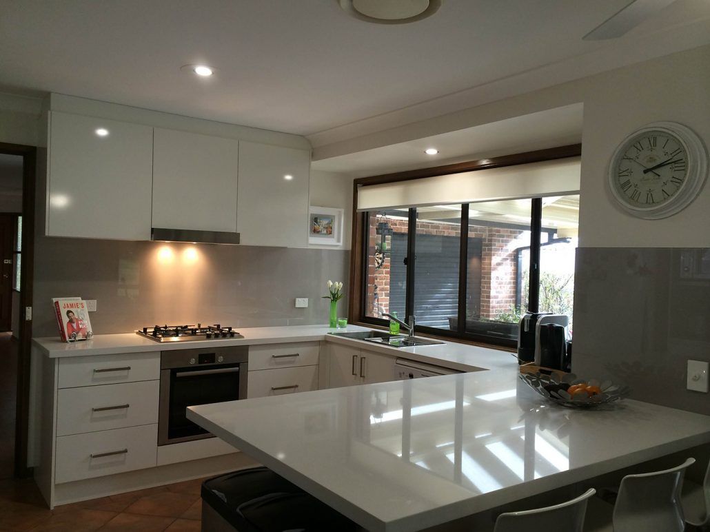 Elegant White Kitchen With Cabinets — Kitchen Designs in Tuggerah, NSW