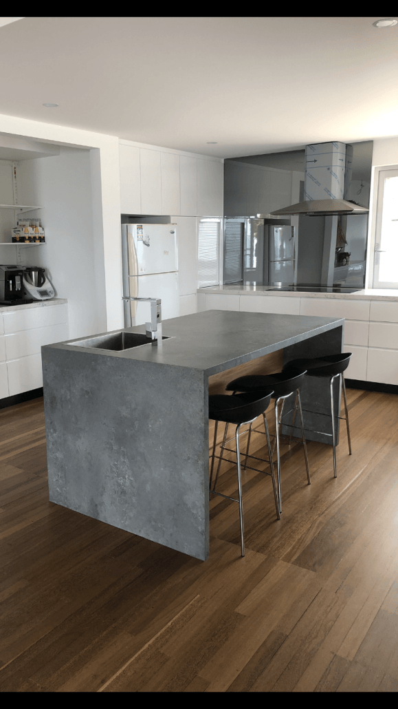 Grey Kitchen Island With Tapware — Kitchen Designer in Belmont, NSW