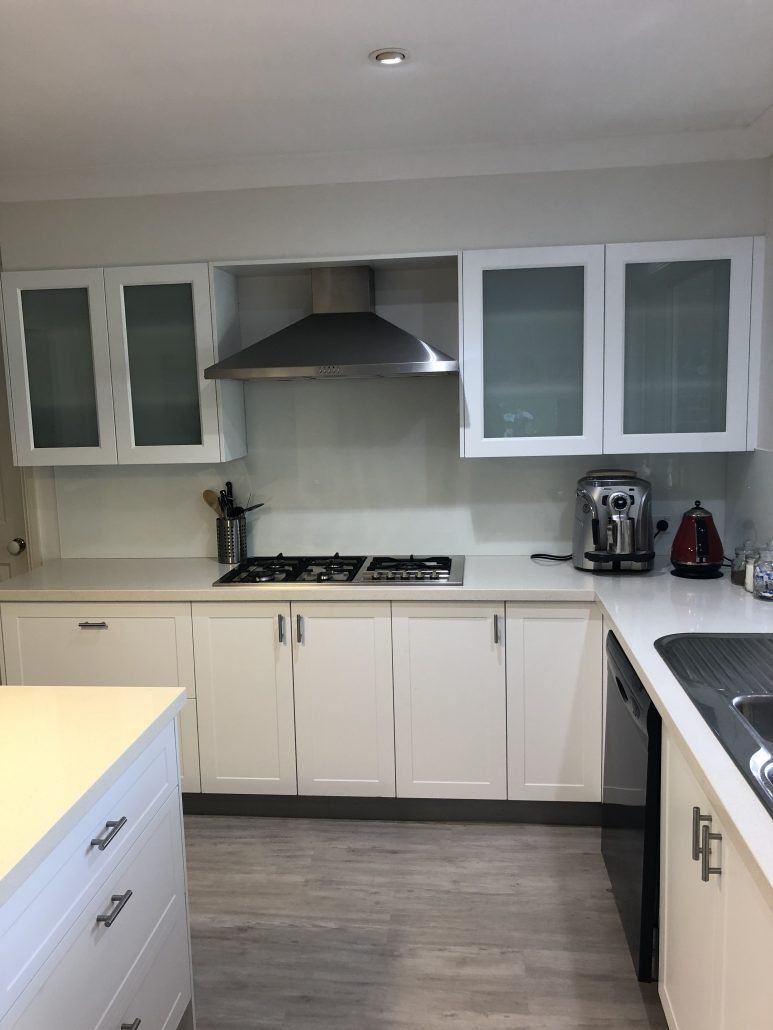 White Kitchen Cabinets With Gas Countertop Stove — Kitchen Designer in Belmont, NSW