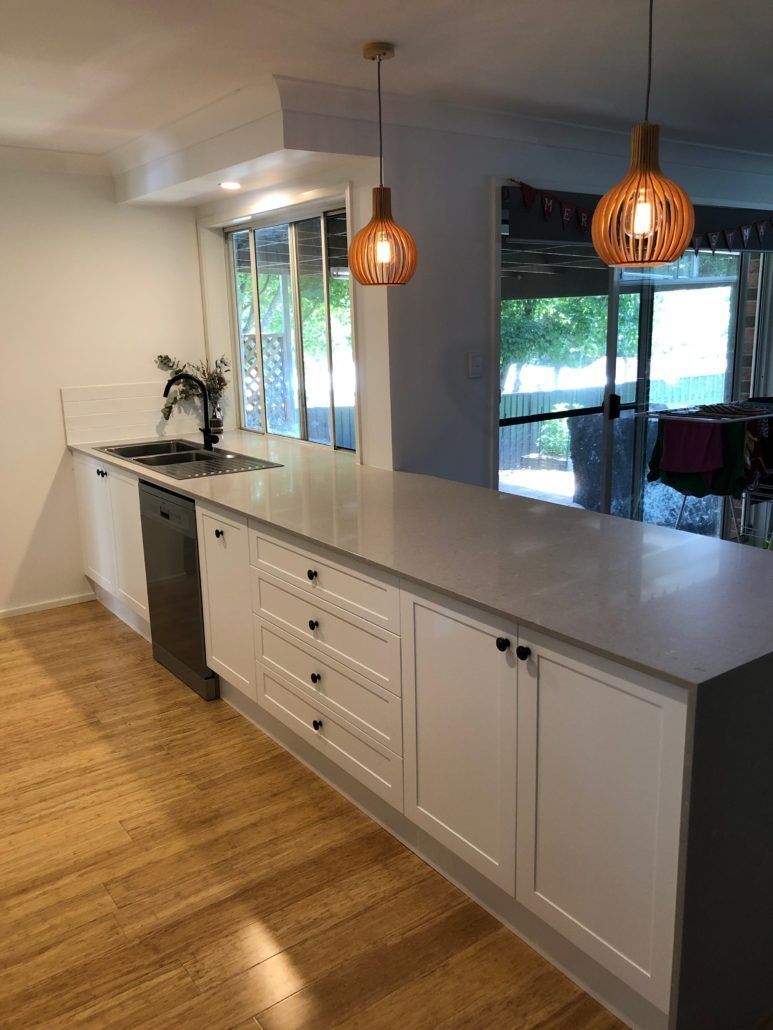 Grey Kitchen Counter With Pendant Lights — Kitchen Designer in Belmont, NSW