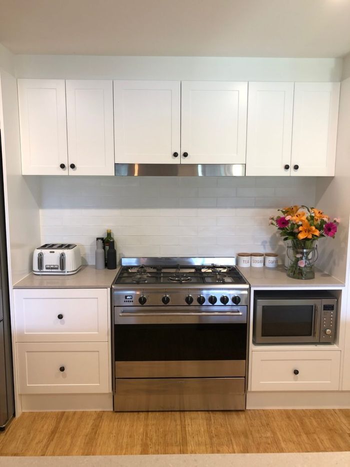 Small Clean Kitchen With White Cabinet Doors — Kitchen Designer in Charmhaven, NSW