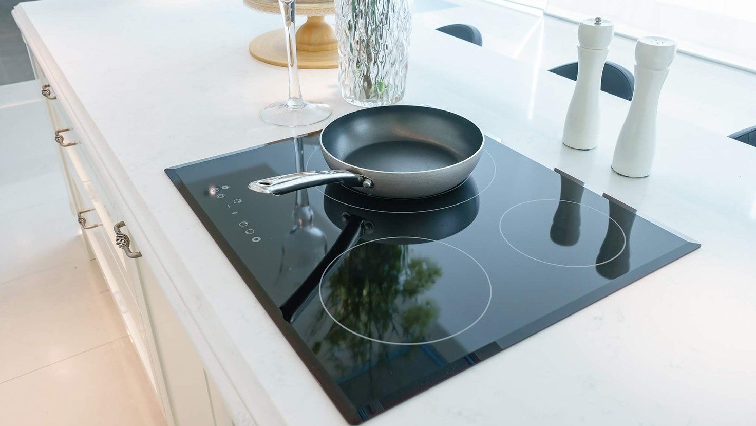Modern Kitchen Interior With Black Induction Cooktops And Pan — Kitchen Designer in Charmhaven, NSW