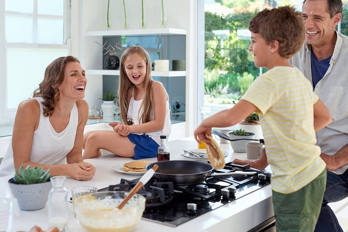 Happy Family Cooking Pancakes — Kitchen Designer in Charmhaven, NSW
