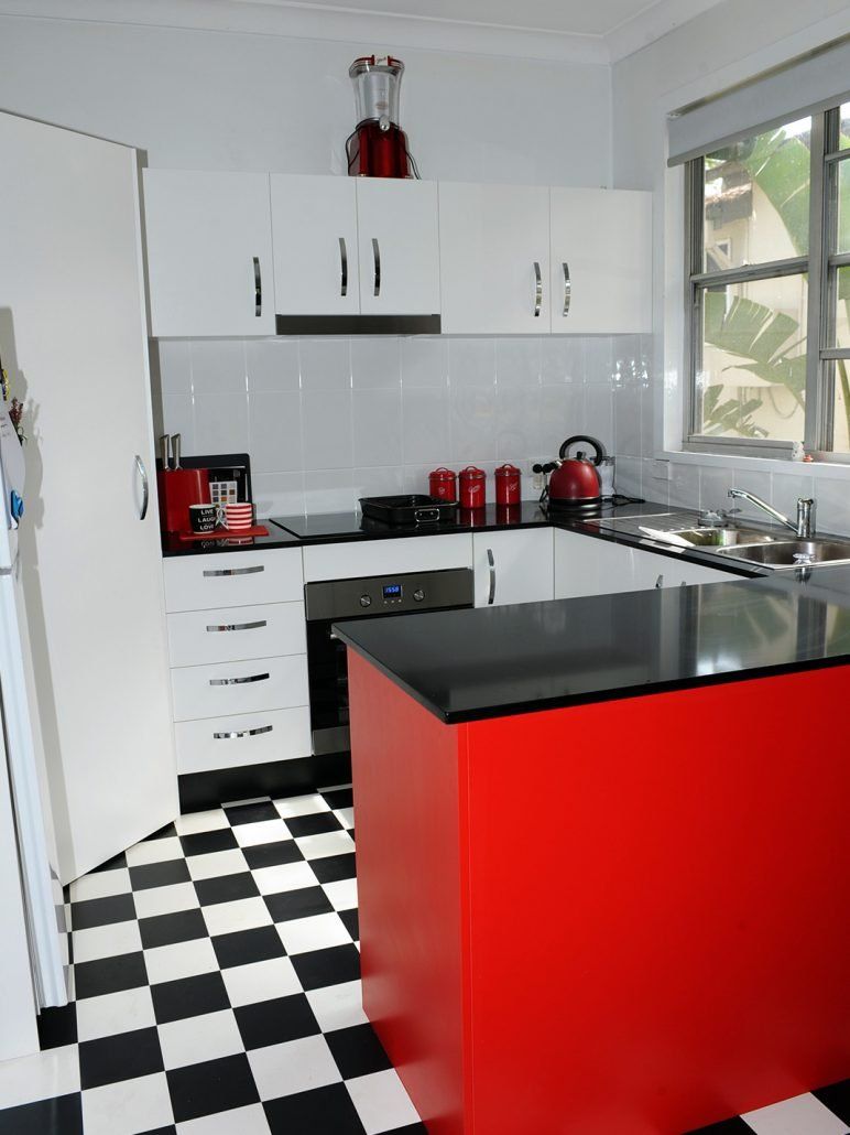 White Kitchen With Black And Red Island — Kitchen Renovations in Charmhaven, NSW