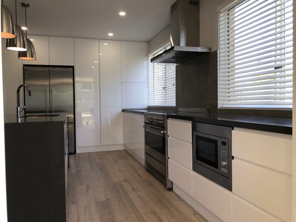 A Kitchen With White Cabinets And Stainless Steel Appliances — Hats Off Kitchens in Sydney Northern Beaches, NSW