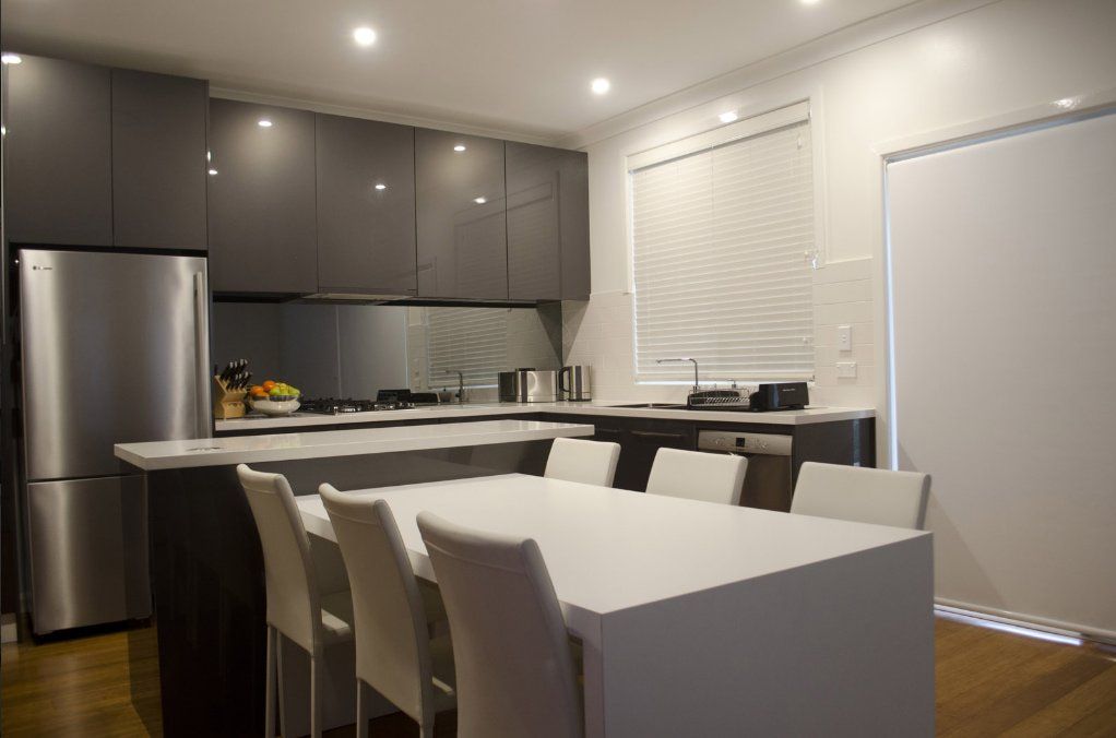 Modern Kitchen And White Dining Table — Kitchen Designer in Morisset, NSW