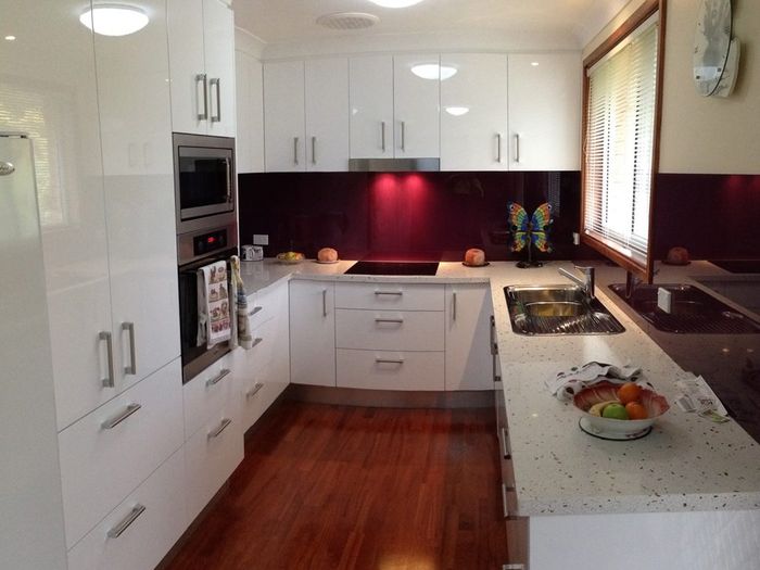 New Renovated Kitchen With Red Splashback — Kitchen Designer in Charmhaven, NSW