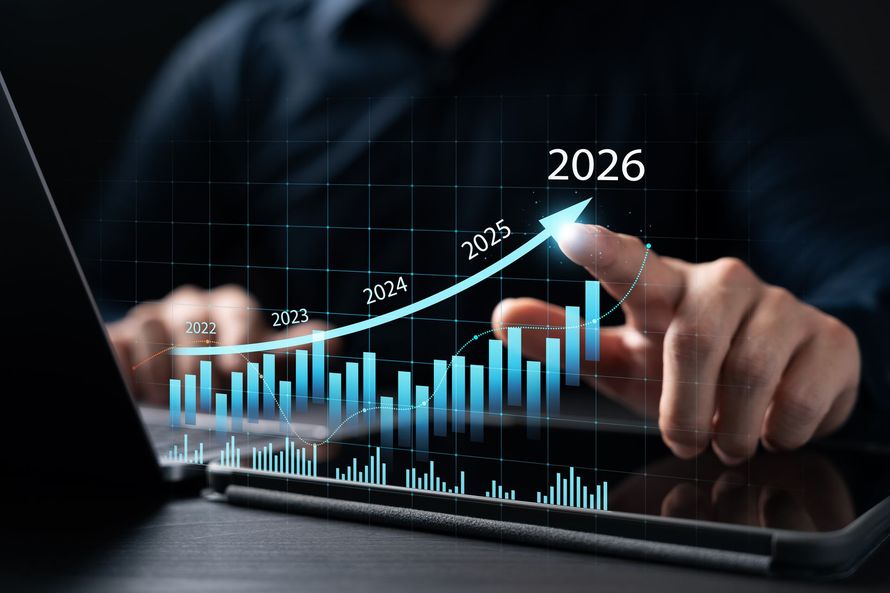 Person pointing at a digital stock chart, with a rising blue line and projected date of 2026.