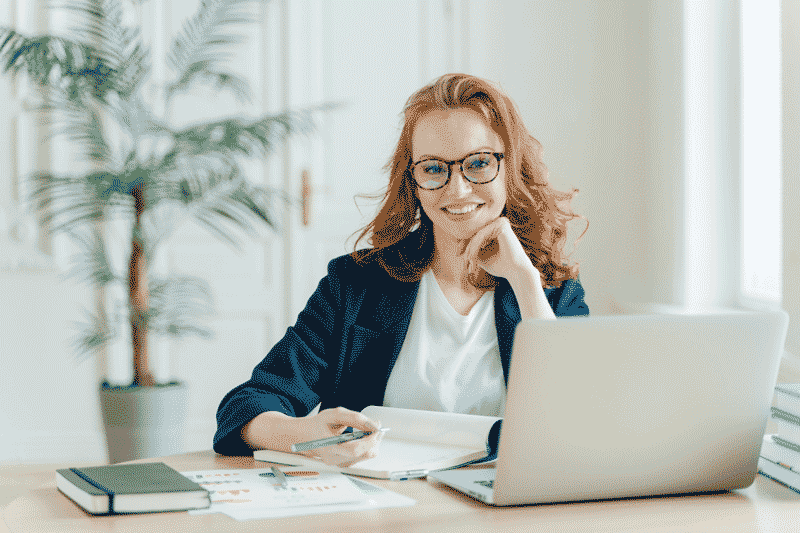 accountant smiling in front of computer