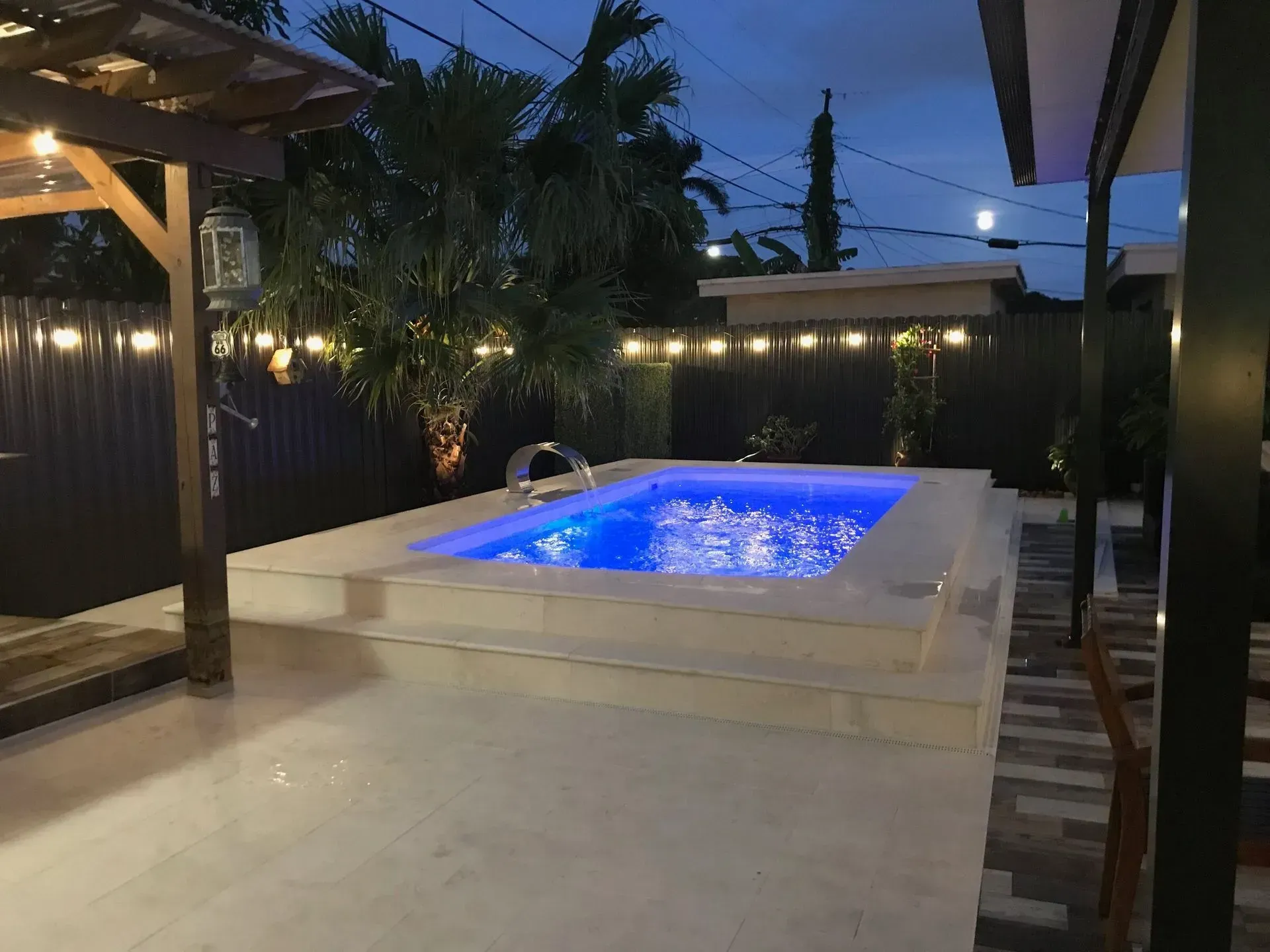 A large swimming pool is lit up at night