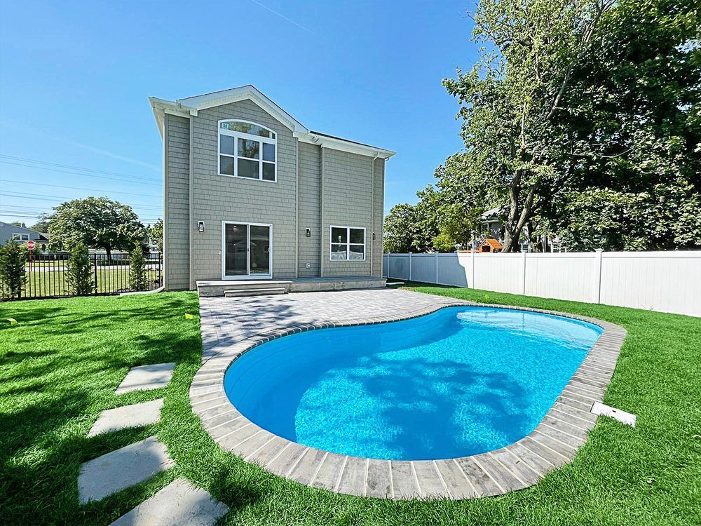 A large house with a large swimming pool in the backyard.