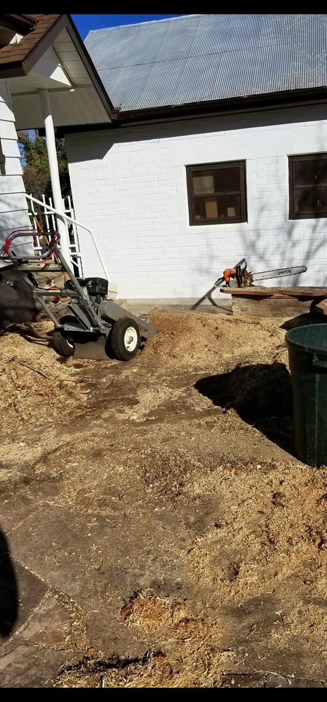 A white house with a lot of dirt in front of it.