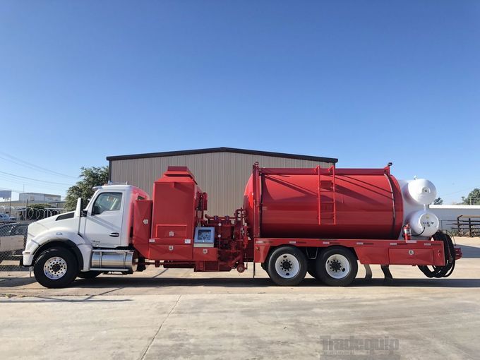 A white water truck is parked in a warehouse.