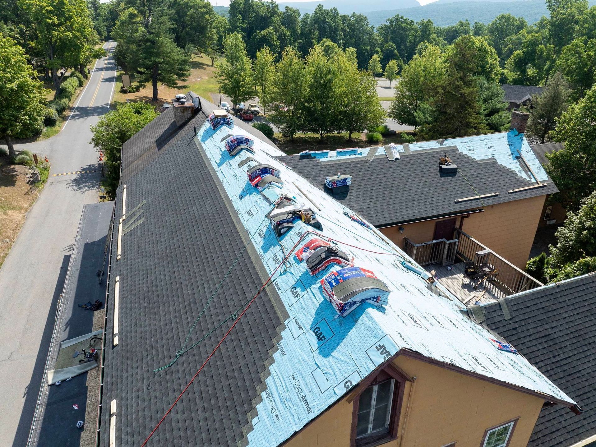 An aerial view of a house with a roof that is being repaired.