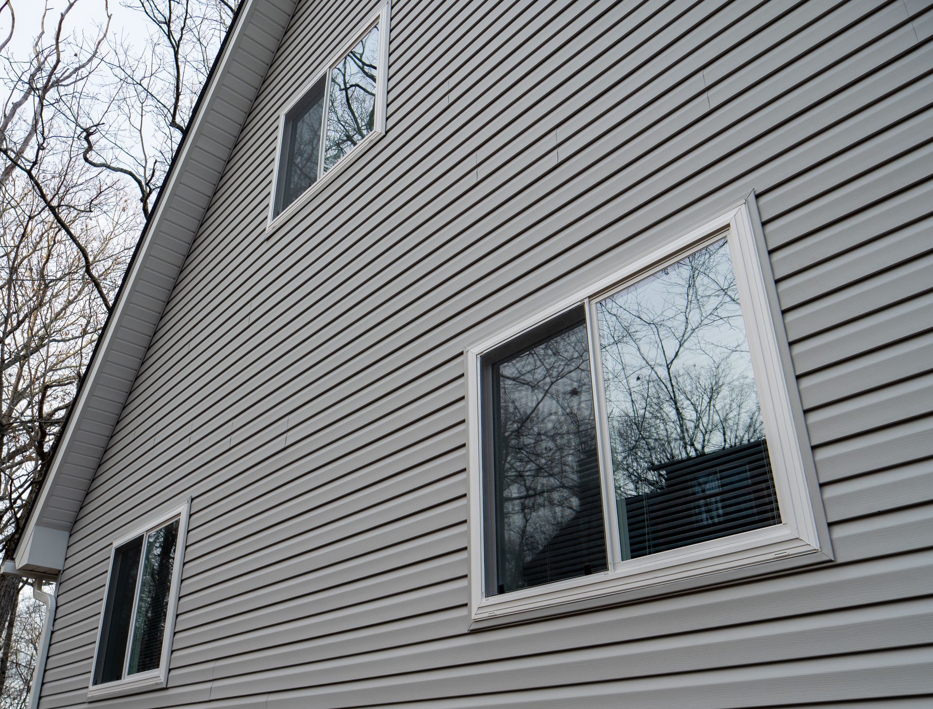 A house with a lot of windows on the side of it.