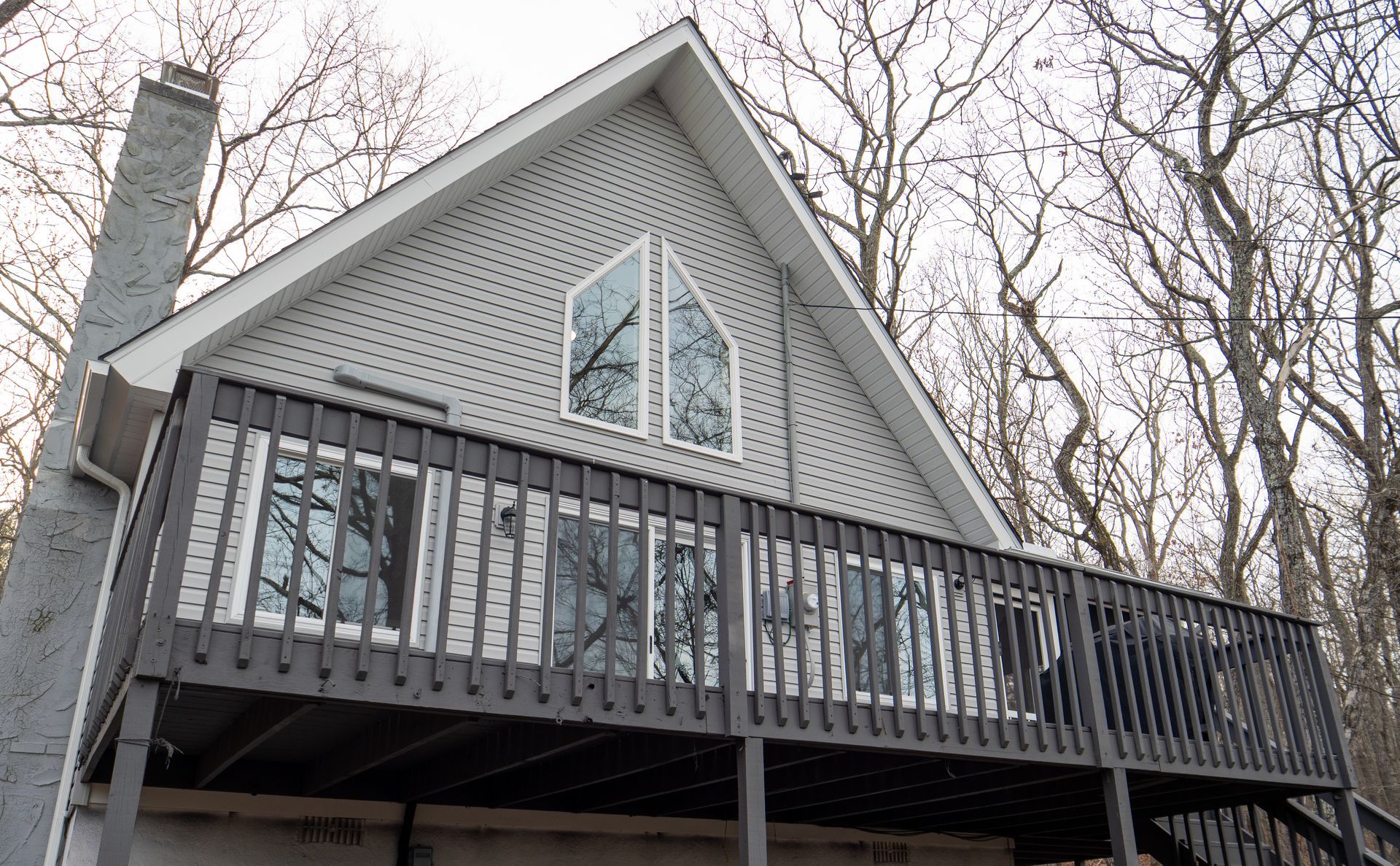 A house with a large deck and a large window