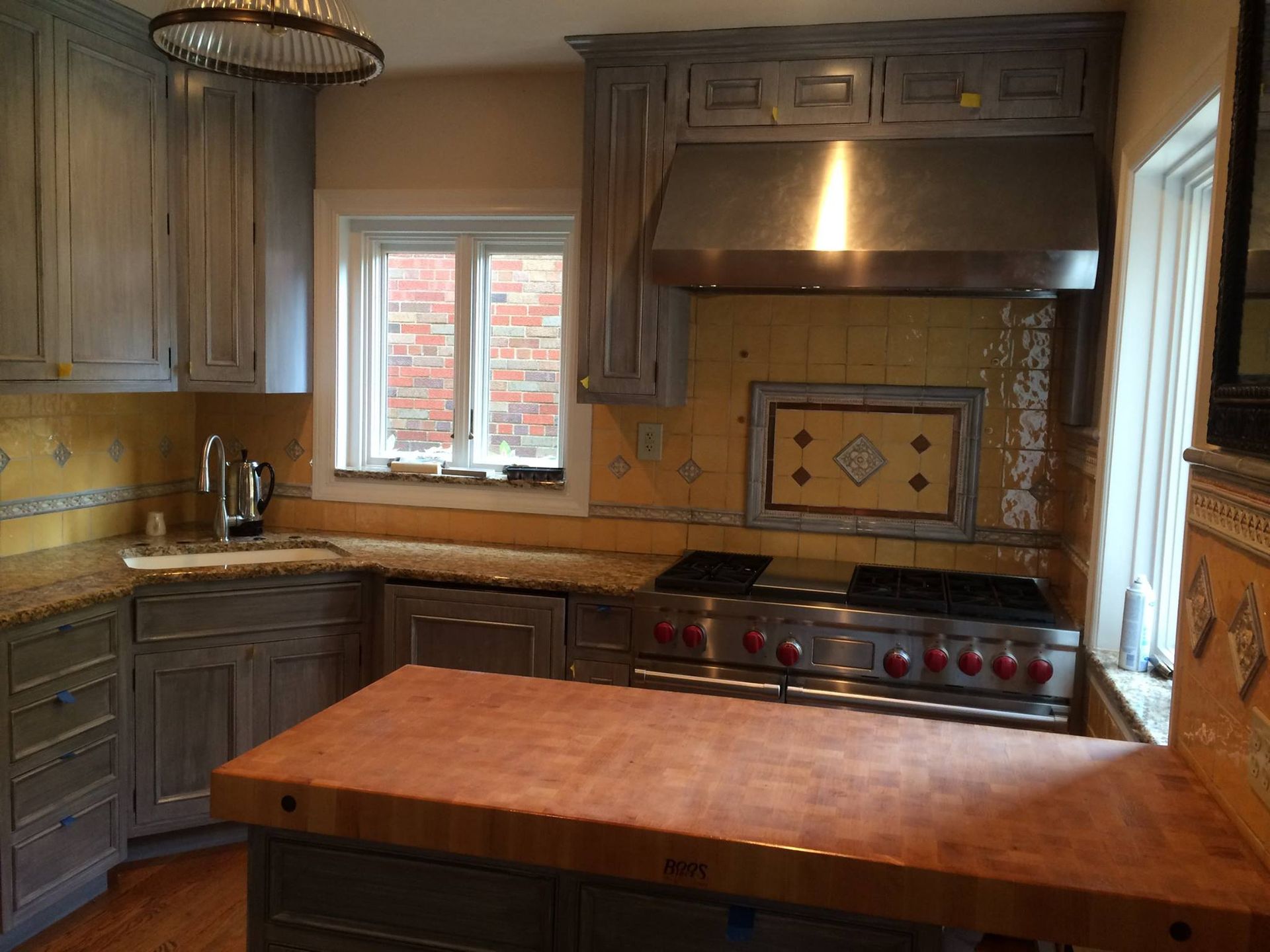 A kitchen with stainless steel appliances and a wooden counter top
