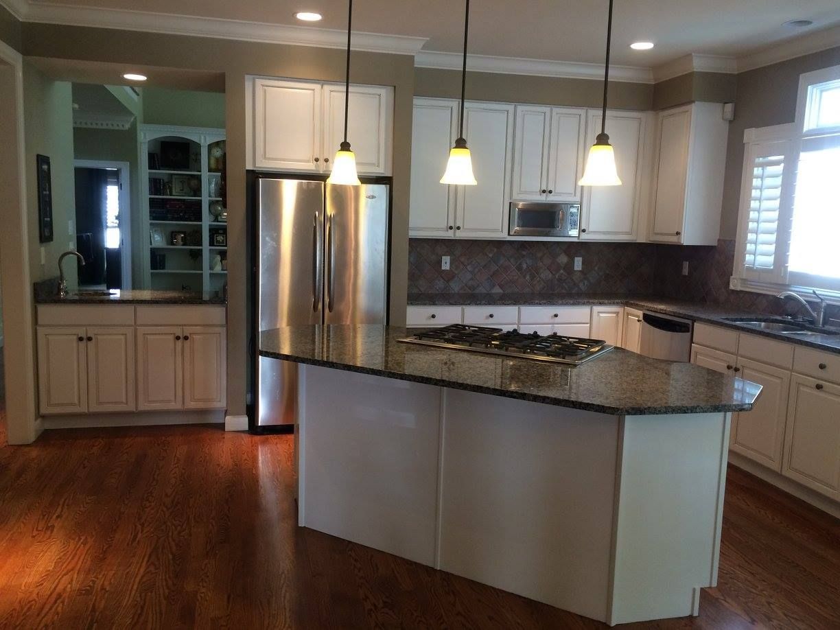 A kitchen with stainless steel appliances and granite counter tops