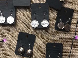 A group of earrings sitting on top of each other on a table.