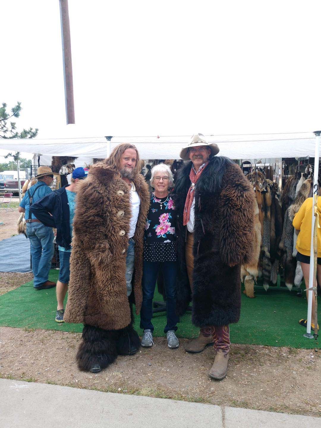 A group of people standing next to each other wearing fur coats.