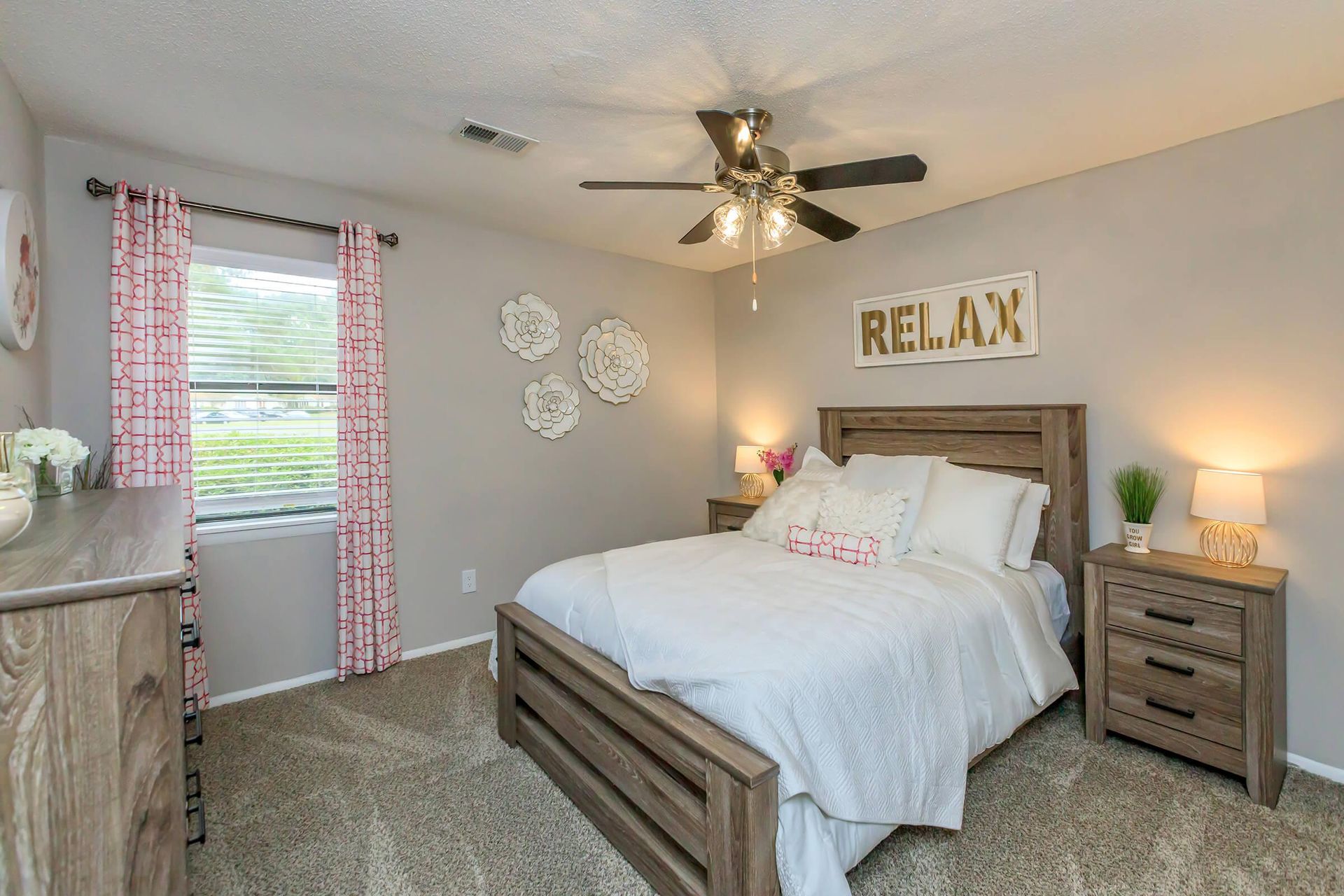 Modern bedroom with furnitures and ceiling fan at The Arbors.