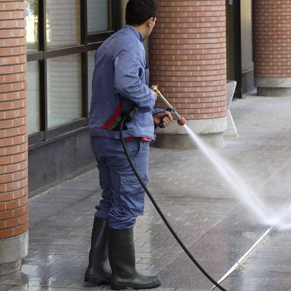 pressure washing sidewalk with a power washer