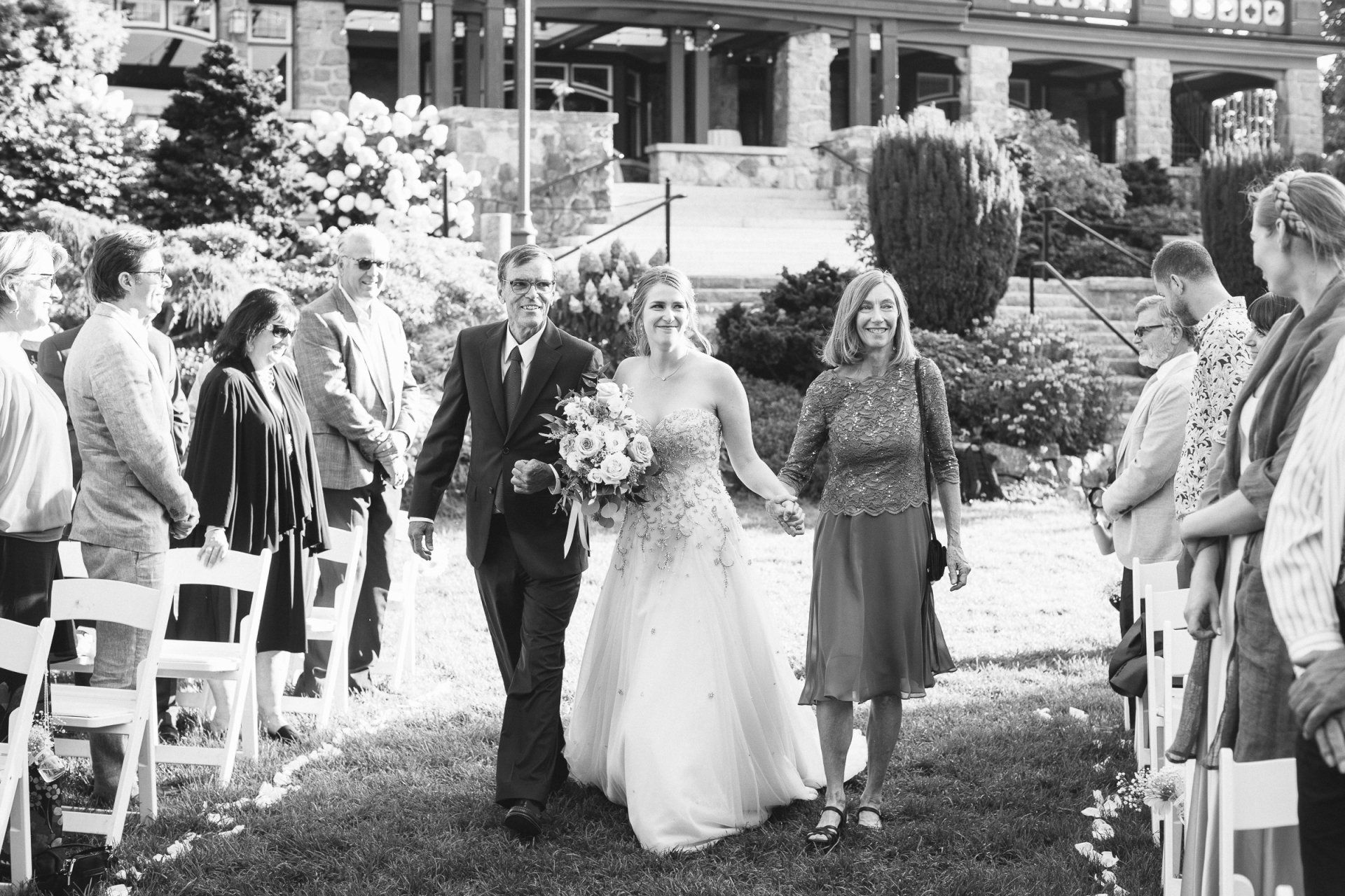 Outdoor wedding - Bride walking down the isle with her parents