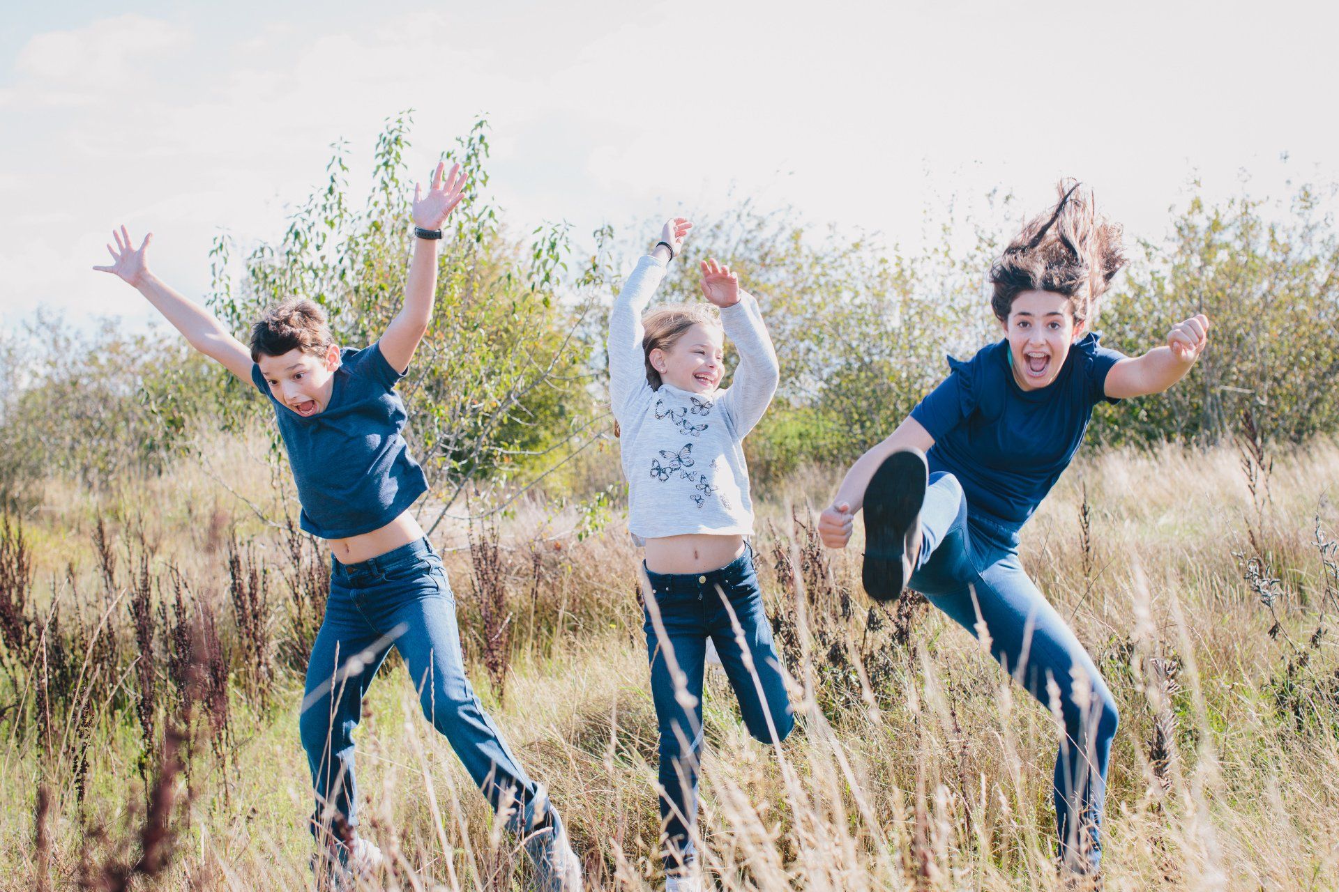 Family photo of the kids playing in a field