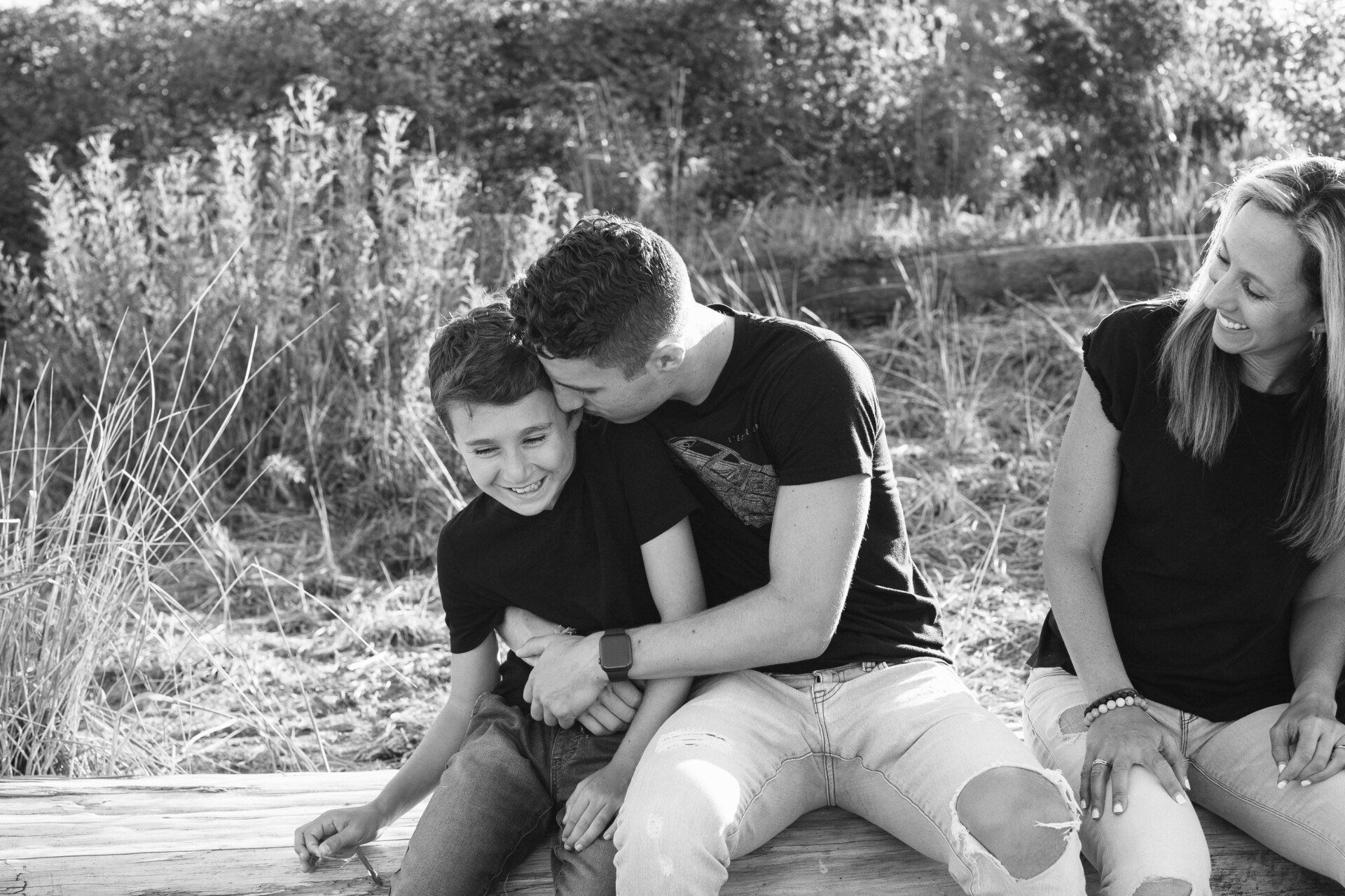 Family photo of a mother with two sons in the park