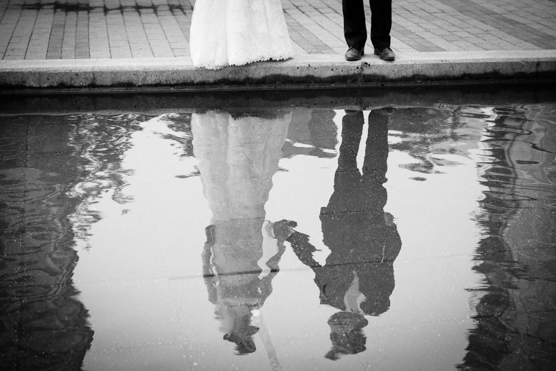 Reflection in the water of a bride and groom