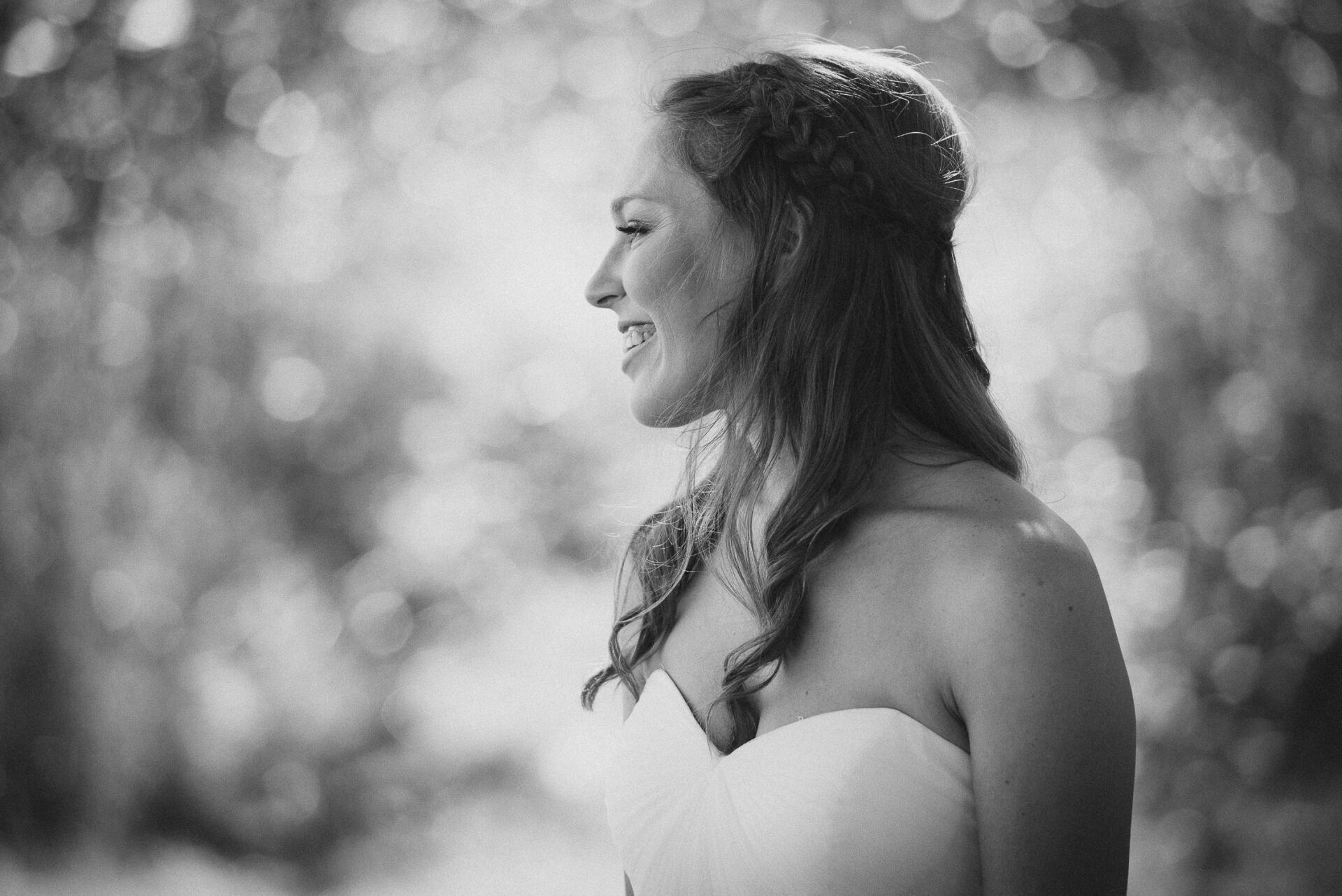 Black and white photo of a bride smiling