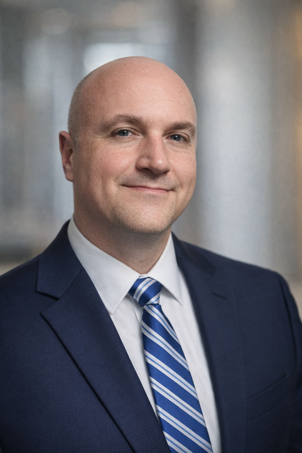 Person coding at a desk with a laptop, monitor displaying code, keyboard, and tablet.