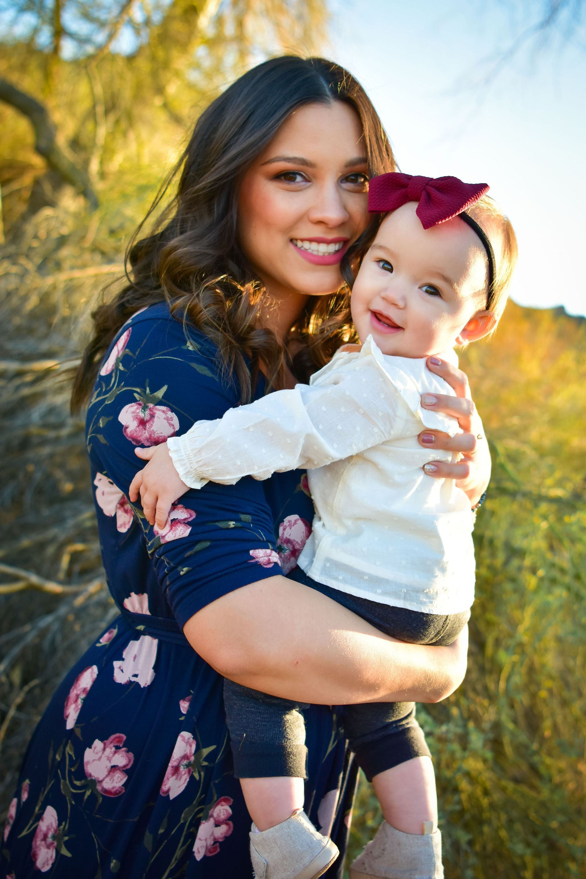 A woman is holding a baby in her arms.