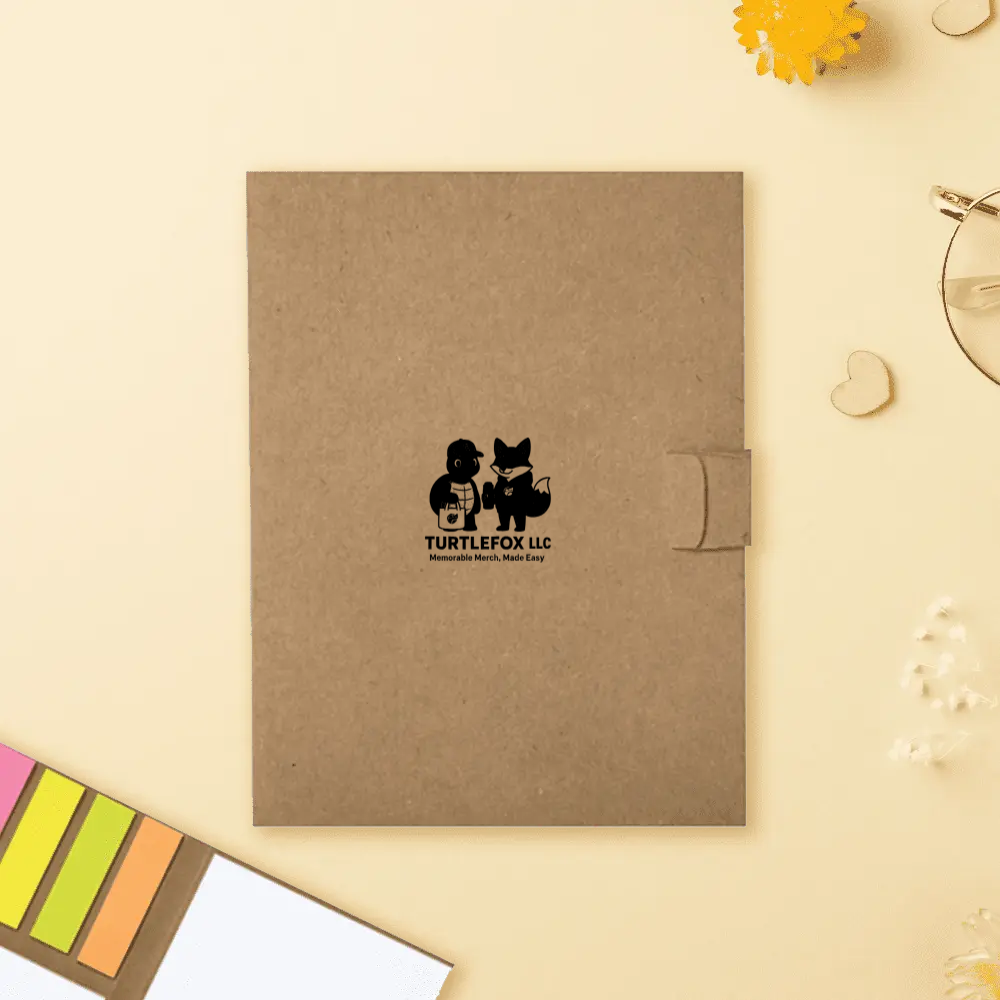 Brown folder with a TurtleFox logo, secured by a tab, surrounded by stationery on a beige surface.