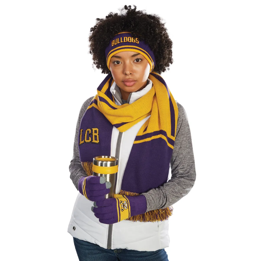 Woman wearing purple/gold Bulldog winter accessories, holding a mug.