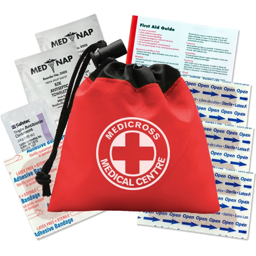 Red Medicross first aid kit with drawstring, bandages, and medication packets.