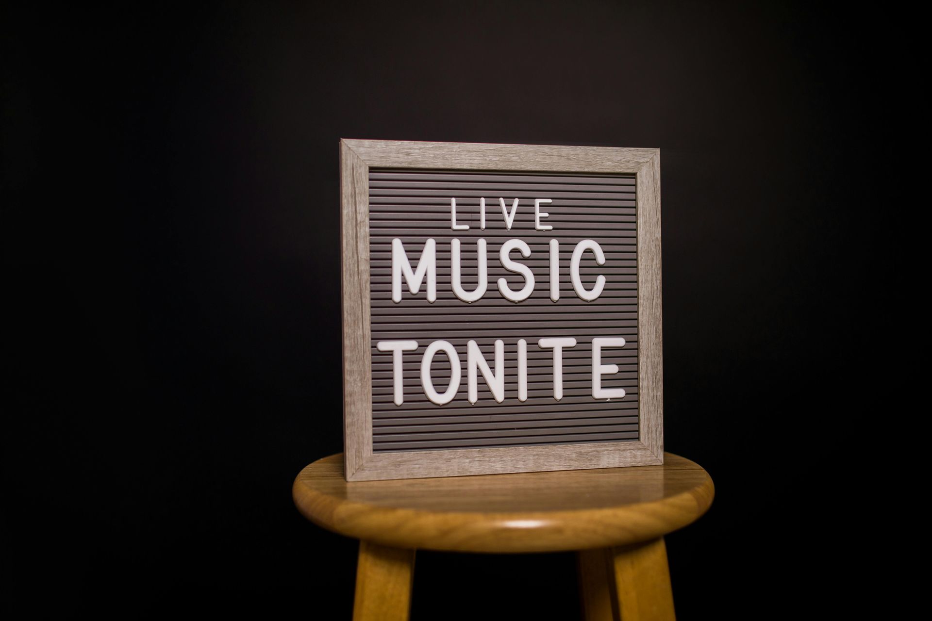Gray letterboard on a stool with 