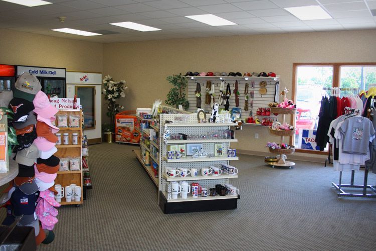 Interior of a gift shop with displays of hats, souvenirs, and clothing.