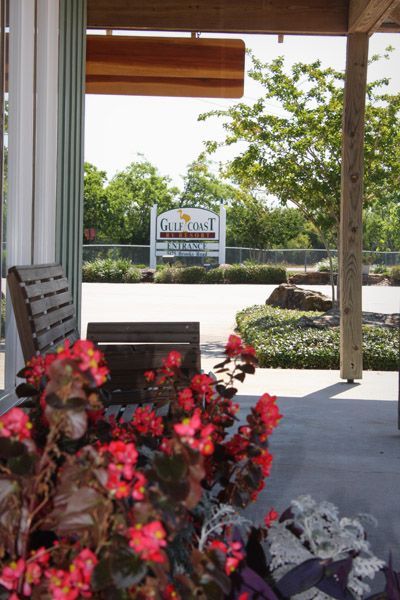 Outdoor view from under a porch of a sign that reads 