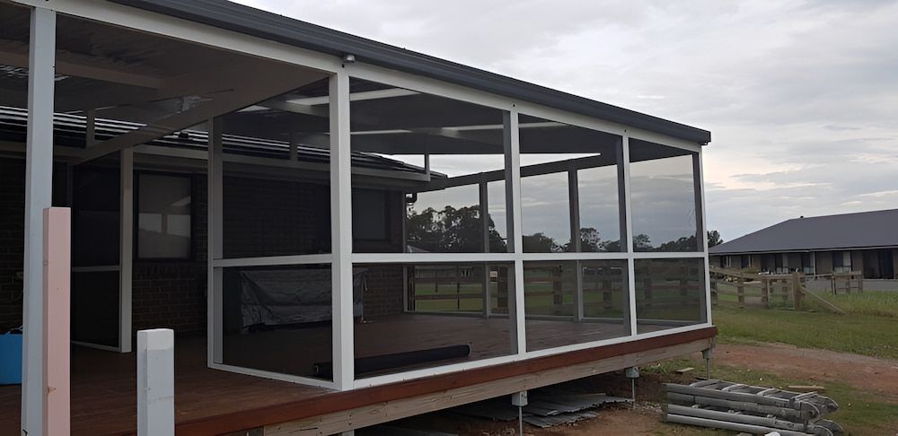 A House With A Screened In Porch And A Large Window — Hunter Home Services in Heddon Greta, NSW